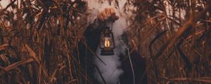 Preview wallpaper lamp, hand, smoke, man, grass, lantern