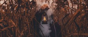 Preview wallpaper lamp, hand, smoke, man, grass, lantern