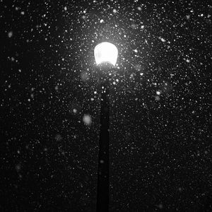 Preview wallpaper lamppost, snow, light, glare, night, bw