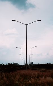 Preview wallpaper lampposts, twilight, sunset, grass