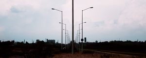 Preview wallpaper lampposts, twilight, sunset, grass