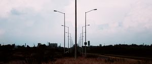 Preview wallpaper lampposts, twilight, sunset, grass