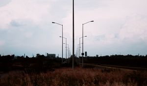 Preview wallpaper lampposts, twilight, sunset, grass