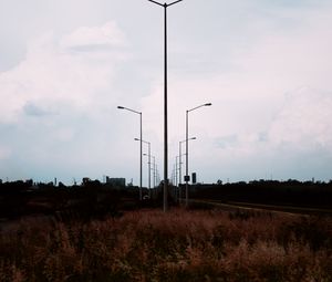 Preview wallpaper lampposts, twilight, sunset, grass