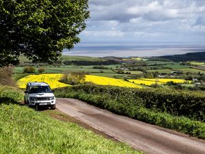 Preview wallpaper land rover, car, suv, white, road, nature