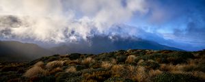 Preview wallpaper landscape, clouds, mountains, hills, bushes