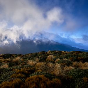 Preview wallpaper landscape, clouds, mountains, hills, bushes