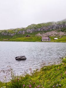 Preview wallpaper landscape, lake, houses, stone, shore, grass