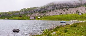 Preview wallpaper landscape, lake, houses, stone, shore, grass