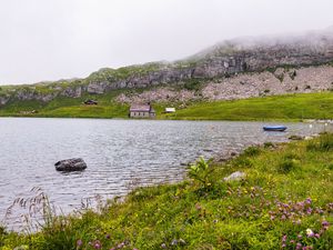 Preview wallpaper landscape, lake, houses, stone, shore, grass