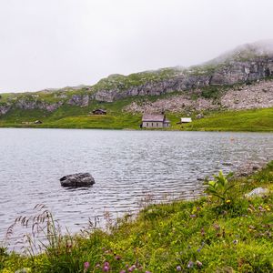 Preview wallpaper landscape, lake, houses, stone, shore, grass