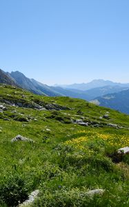 Preview wallpaper landscape, slope, grass, stones, mountains, sky