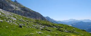 Preview wallpaper landscape, slope, grass, stones, mountains, sky