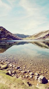 Preview wallpaper landscape, stones, coast, lake, mountains, colors, faded, inscription