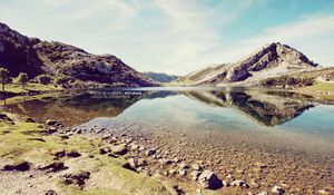 Preview wallpaper landscape, stones, coast, lake, mountains, colors, faded, inscription