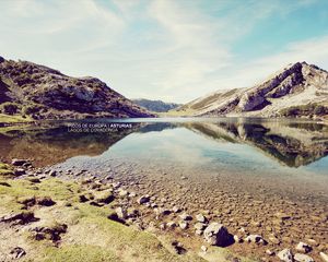 Preview wallpaper landscape, stones, coast, lake, mountains, colors, faded, inscription