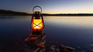 Preview wallpaper lantern, light, stones, lake, shore