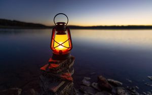 Preview wallpaper lantern, light, stones, lake, shore