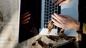 Preview wallpaper laptop, hands, work, leaves, autumn, aesthetics