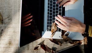 Preview wallpaper laptop, hands, work, leaves, autumn, aesthetics