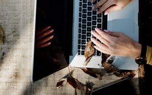 Preview wallpaper laptop, hands, work, leaves, autumn, aesthetics