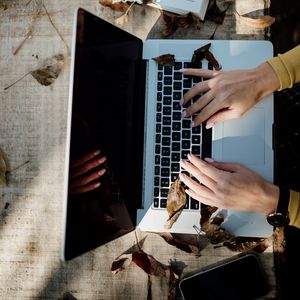 Preview wallpaper laptop, hands, work, leaves, autumn, aesthetics