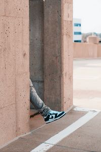 Preview wallpaper leg, sneakers, building, wall