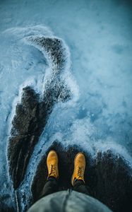 Preview wallpaper legs, boots, water, shore, stone