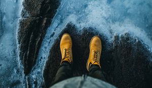 Preview wallpaper legs, boots, water, shore, stone