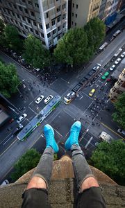 Preview wallpaper legs, roof, road, cars, buildings, aerial view