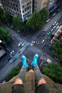 Preview wallpaper legs, roof, road, cars, buildings, aerial view