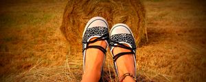 Preview wallpaper legs, shoes, hay, grass, sit