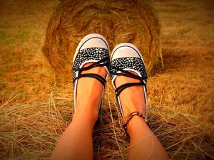 Preview wallpaper legs, shoes, hay, grass, sit