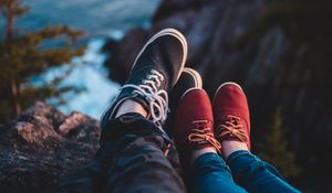 Preview wallpaper legs, shoes, sneakers, cliff, sea