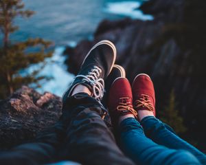 Preview wallpaper legs, shoes, sneakers, cliff, sea