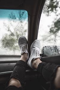 Preview wallpaper legs, sneakers, car, glass, rain