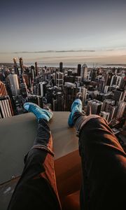 Preview wallpaper legs, sneakers, city, aerial view