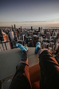 Preview wallpaper legs, sneakers, city, aerial view