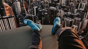Preview wallpaper legs, sneakers, city, aerial view