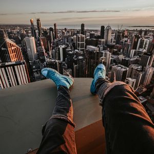 Preview wallpaper legs, sneakers, city, aerial view