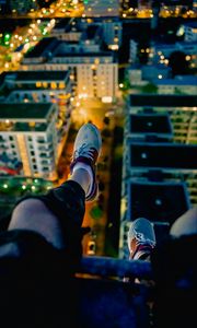 Preview wallpaper legs, sneakers, city, lights, aerial view