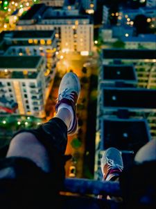Preview wallpaper legs, sneakers, city, lights, aerial view