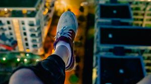 Preview wallpaper legs, sneakers, city, lights, aerial view