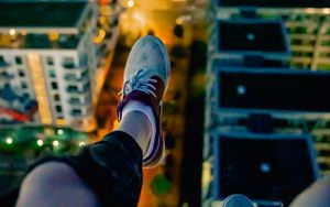 Preview wallpaper legs, sneakers, city, lights, aerial view