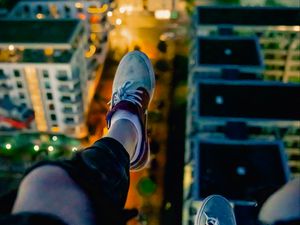 Preview wallpaper legs, sneakers, city, lights, aerial view