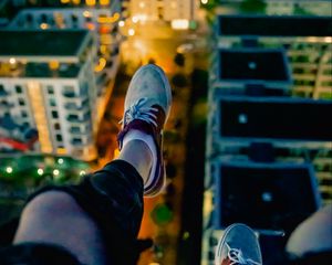 Preview wallpaper legs, sneakers, city, lights, aerial view