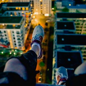 Preview wallpaper legs, sneakers, city, lights, aerial view