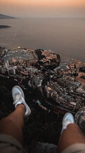 Preview wallpaper legs, sneakers, city, aerial view, coast