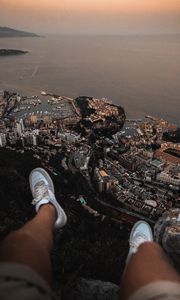 Preview wallpaper legs, sneakers, city, aerial view, coast