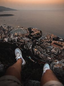 Preview wallpaper legs, sneakers, city, aerial view, coast